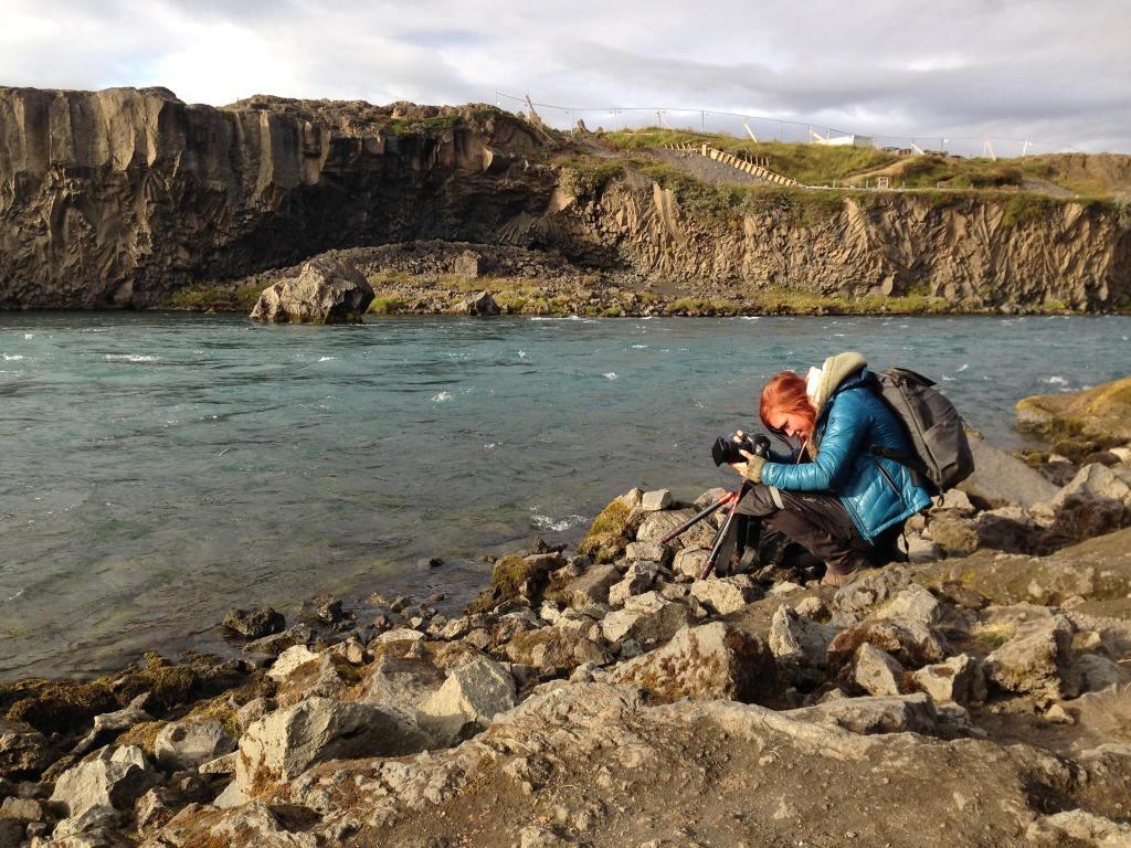 Henna Metz photographing along a river in Iceland